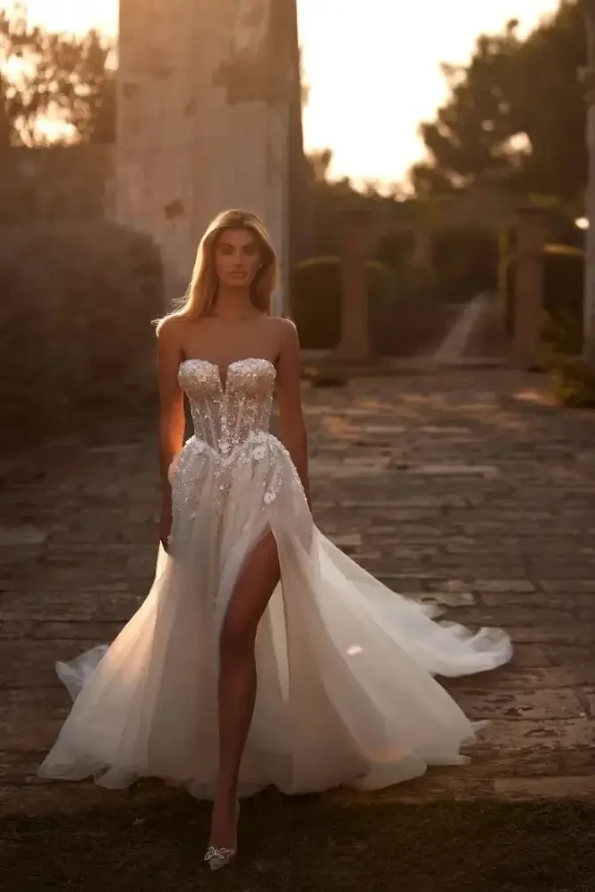 Model wearing an A-line wedding gown with 3D flowers