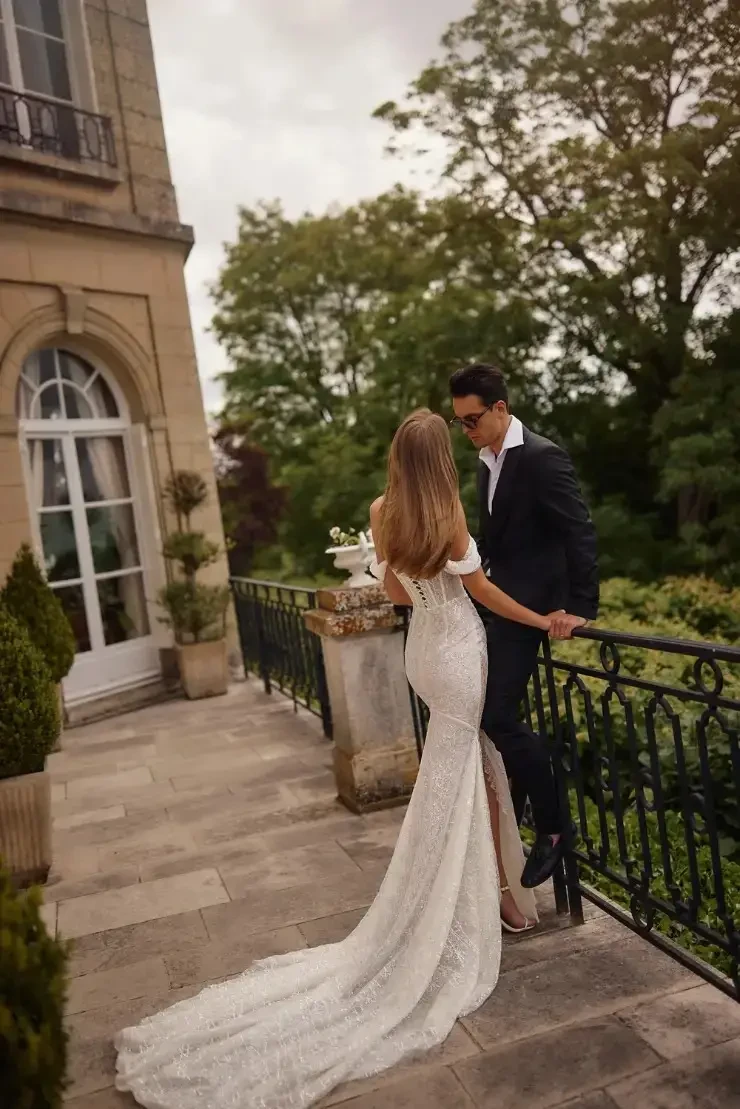Model wearing an off the shoulder bridal gown by Eva Lendel