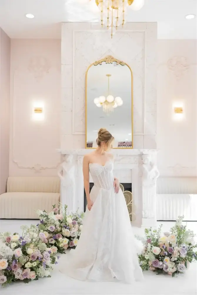 model is wearing a strapless drop waist wedding gown