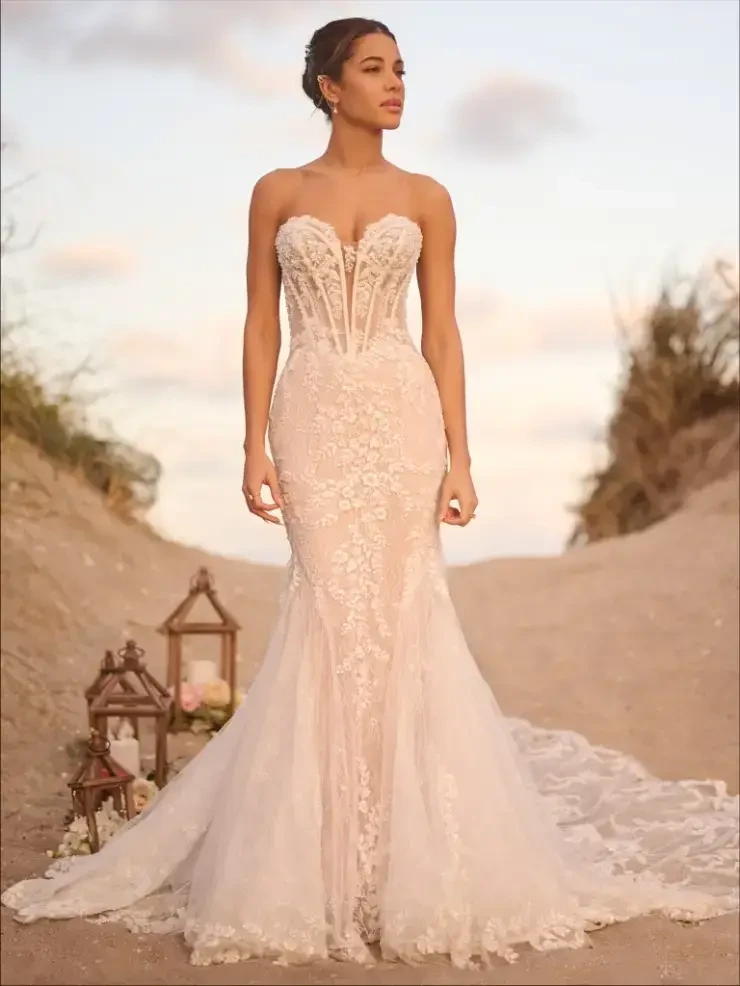 model is wearing a strapless lace fitted wedding dress