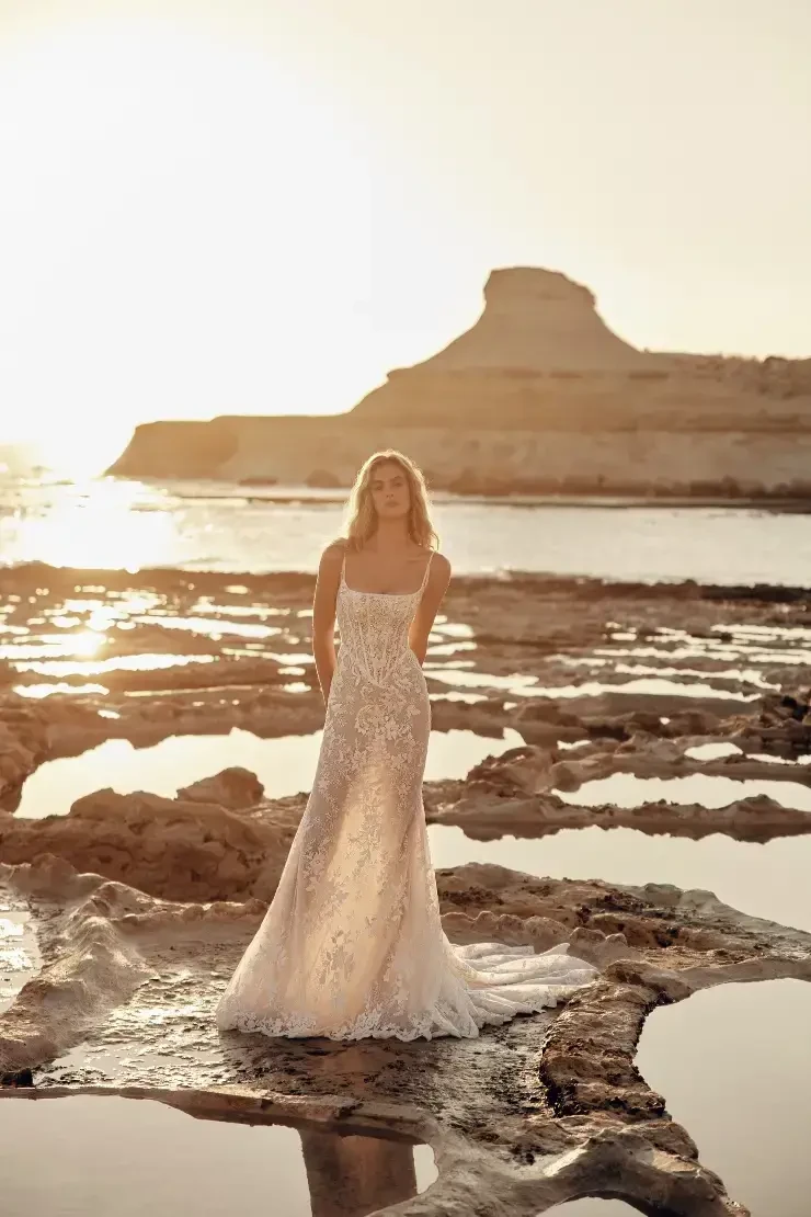 model is wearing a fitted lace bridal gown