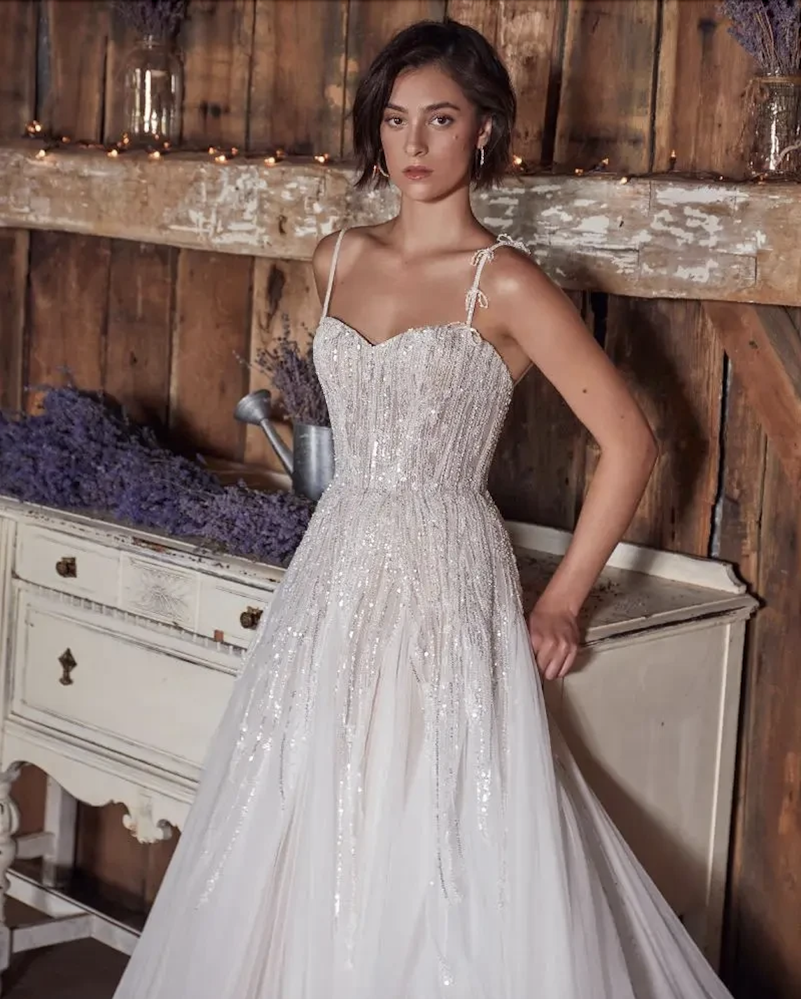 Model wearing a lace and tulle wedding dress by Eva Lendel 