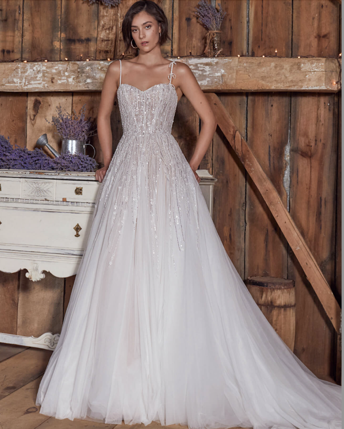 Model wearing a lace and tulle wedding dress by Eva Lendel 