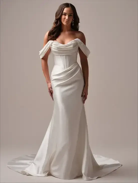 model is wearing a romantic off the shoulder fit and flare bridal gown